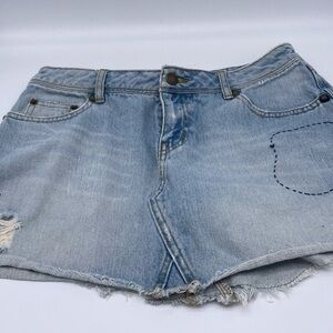 Free People denim distressed mini skirt.